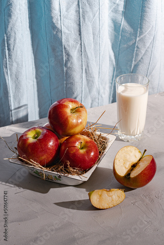 country breakfast on rustic home kitchen with farm apples and milk. Organic homemade food.
