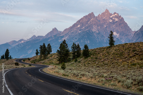 Winding Road Climbs Hillside in front of the Tetons