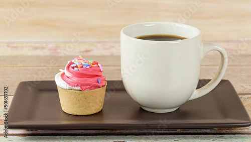 Closeup of a mini pie with Sablee pastry and whipped cream topping, next to a cup of coffee (side view). photo