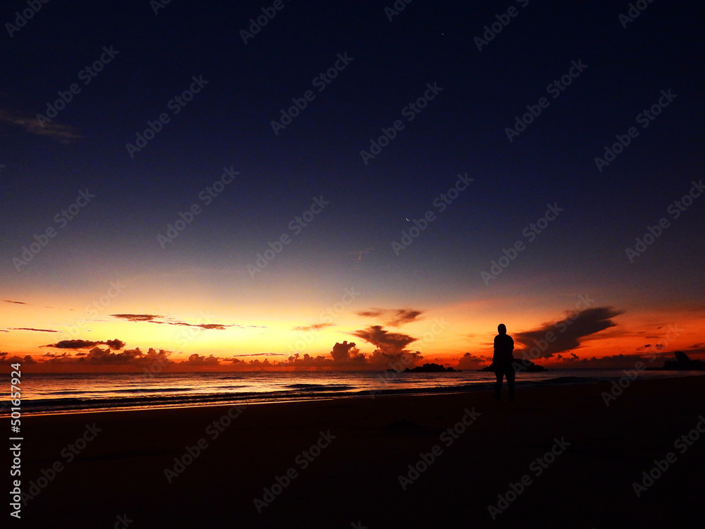 Obraz premium Women walking alone at the beach early in the morning