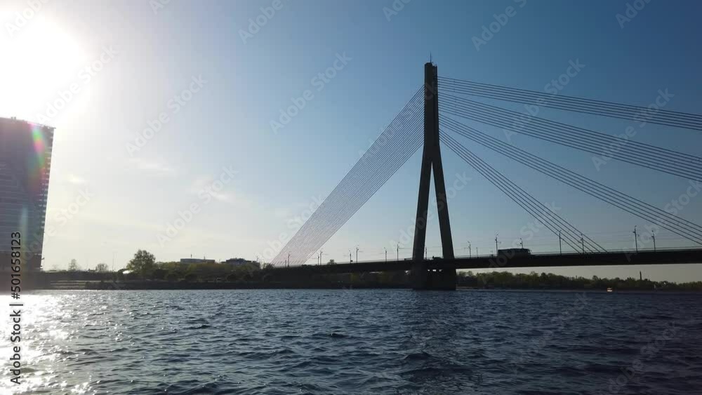 Aboard a boat in Riga approaching the Vanšu Bridge.Backlit Aboard a boat in Riga approaching the Vanšu Bridge.Backlit