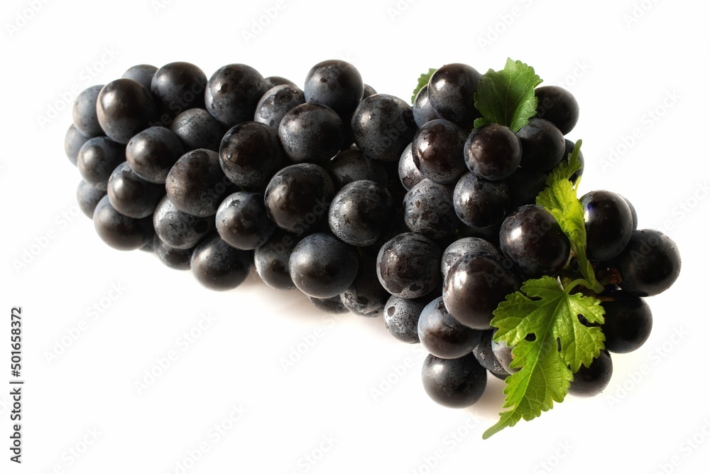 black grape fruit with green leaves isolated on white background black grape fruit with green leaves isolated on white background