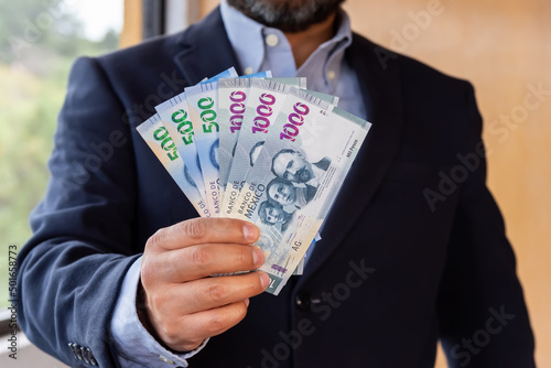 Man counting  money - mexican pesos