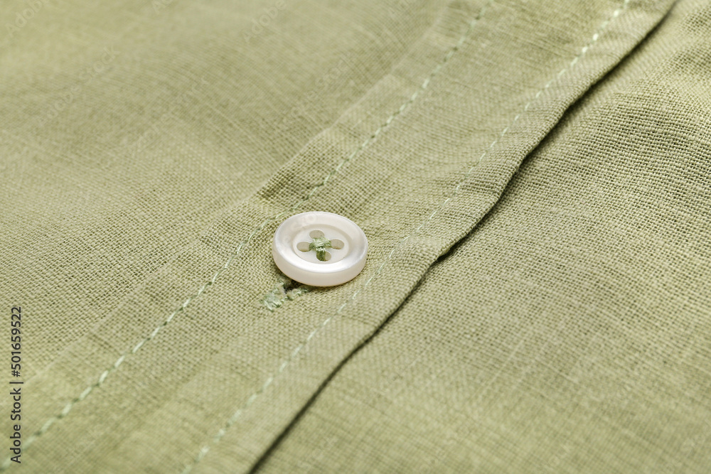 Closeup view of linen male shirt with button Closeup view of linen male shirt with button