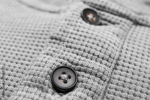 Closeup view of buttons on grey male shirt