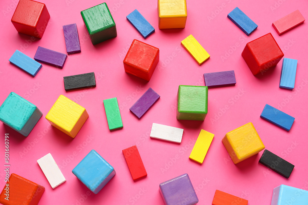 Colorful cubes with blocks on pink background