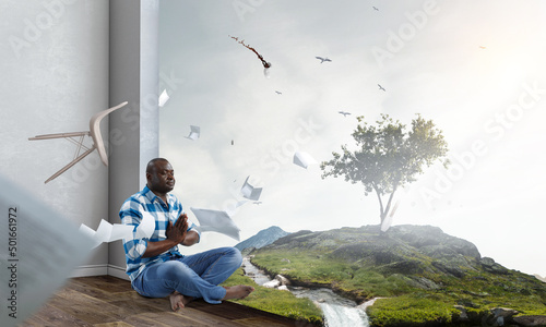 Young black man sitting and meditating