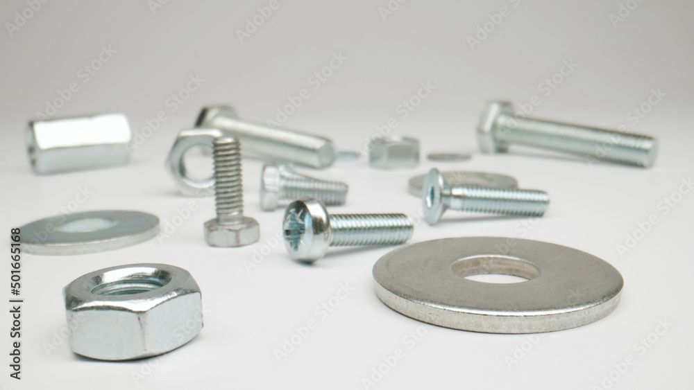 MACRO: Bolts, nuts on a white background MACRO: Bolts, nuts on a white background