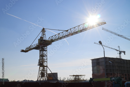 Tower cranes are working on the construction of a new house. Lifting crane. photo