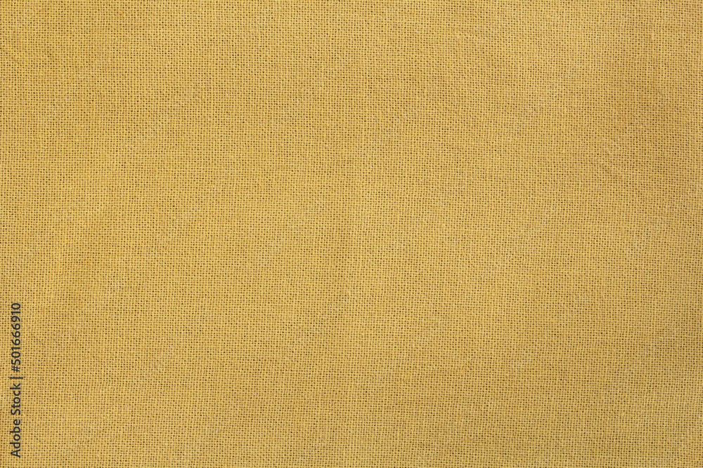 Fototapeta premium Yellow textile cloth with streak design and wrinkles for the background.