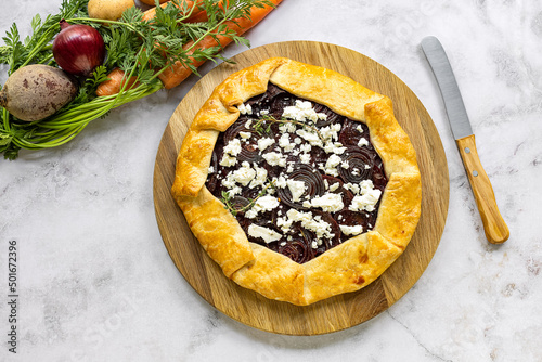 Process of preparing savory root vegetable galette. Step by step recipe. Ready open pie from the oven, served with goat cheese.