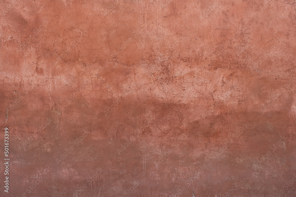 Fototapeta premium A stone wall with old paint of rough texture and cracks close-up. Background for designers.
