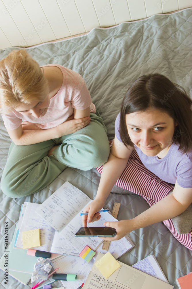 Teaching concept from above. Two gen z teenagers preparing exam. Teaching concept from above. Two gen z teenagers preparing exam.
