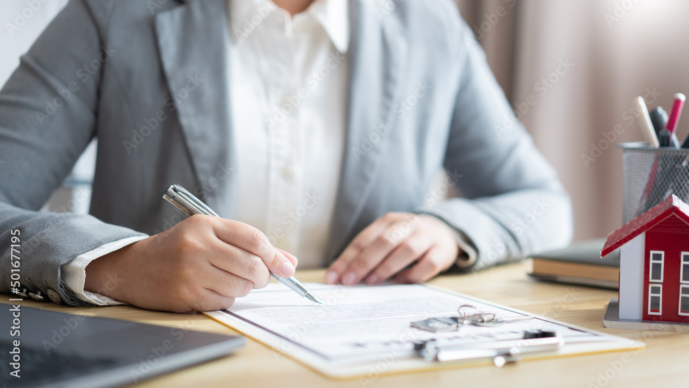 Insurance concept the realtor dealing with a customer and signing on a contract of property Insurance concept the realtor dealing with a customer and signing on a contract of property