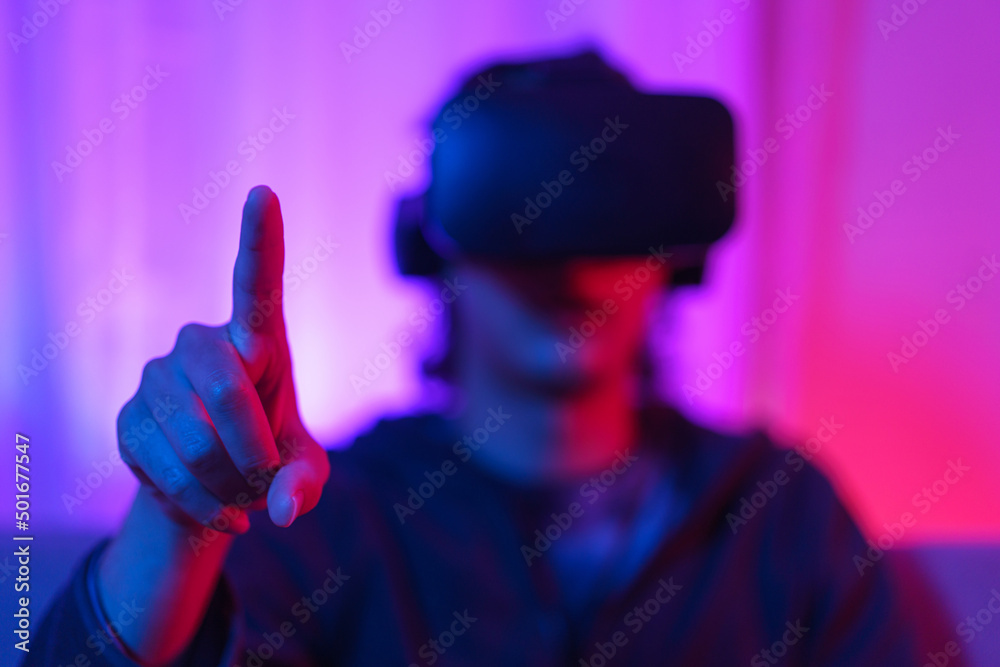 Metaverse technology concept, Man wear VR goggles and pointing to touch experience in virtual world Metaverse technology concept, Man wear VR goggles and pointing to touch experience in virtual world