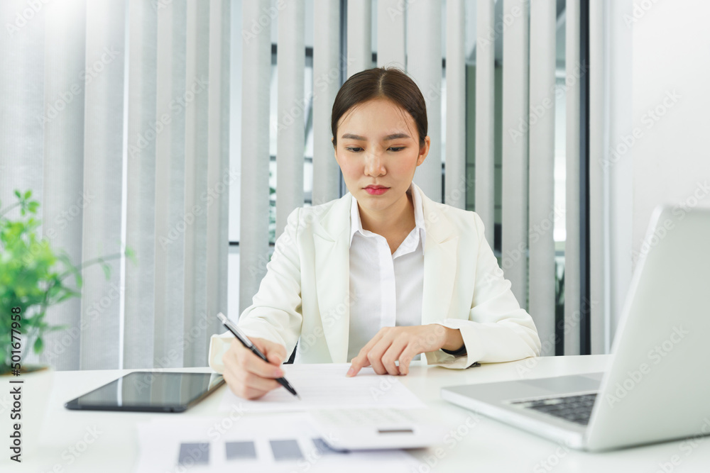 Confidence woman concept, Businesswoman analyzing strategy of business and writing data on document Confidence woman concept, Businesswoman analyzing strategy of business and writing data on document