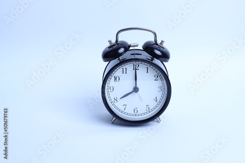 black vintage style alarm clock isolated on a white background