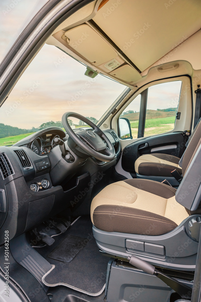 Interior of the front of a camper van with driver seat