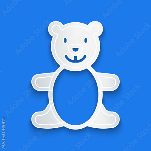 Paper cut Teddy bear plush toy icon isolated on blue background. Paper art style. Vector