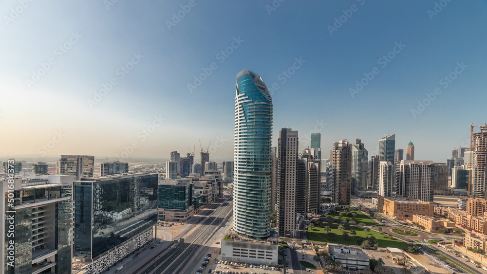 Obraz premium Panorama showing Dubai's business bay towers aerial morning timelapse. Rooftop view of some skyscrapers