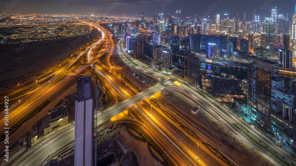 Panorama showing skyline of Dubai with business bay and downtown district night timelapse.