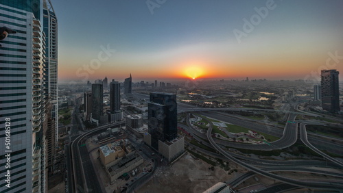 Sunrise over media city and al barsha heights district area night to day timelapse from Dubai marina.