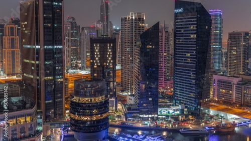 Dubai Marina Skyline with JLT district skyscrapers on a background aerial night to day timelapse.