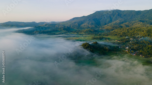 Fototapeta Naklejka Na Ścianę i Meble -  Aerial view, sea of fog covering the village in the morning