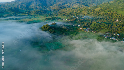 Aerial view  sea of fog covering the village in the morning