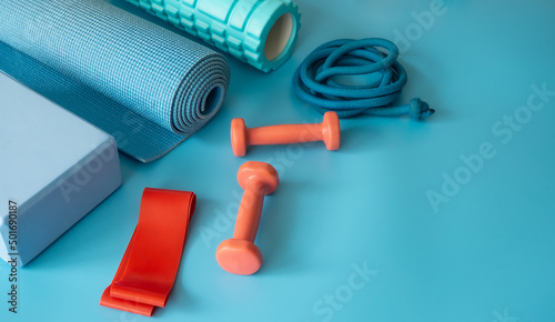 Sports equipment for fitness. Fitness and healthy lifestyle. Blue background.