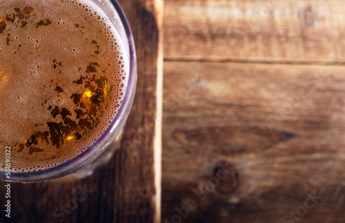 Glass of beer  in a rustic style with a place for text. Top view drin background