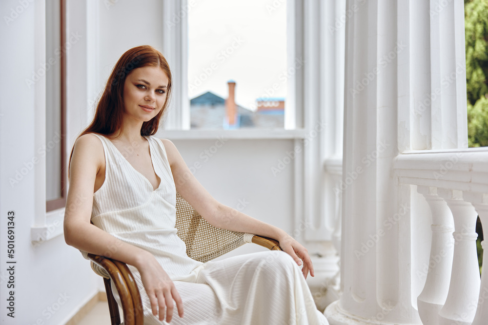 portrait of pretty woman in white dress sitting outdoors on the terrace portrait of pretty woman in white dress sitting outdoors on the terrace