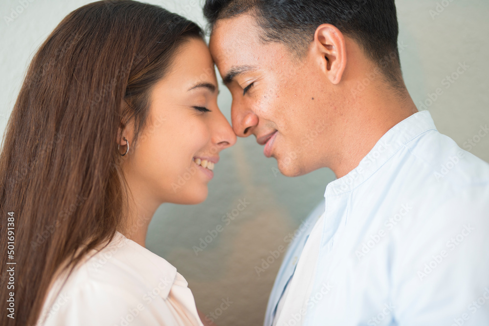 Young adult Z generation touching each other front with the head and smile. Romantic and relationship activity with boy and girl in love. Happy people couple with closed eyes dreaming future Young adult Z generation touching each other front with the head and smile. Romantic and relationship activity with boy and girl in love. Happy people couple with closed eyes dreaming future