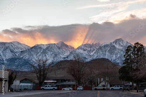 A jacobs ladder is visible as the sun is setting behind mount whitney in Lone Pine california.
