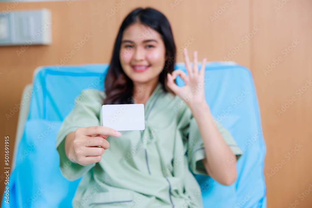 white card mockup in asian Beautiful woman patient hand sitting in hospital bed at medical center. white card mockup in asian Beautiful woman patient hand sitting in hospital bed at medical center.