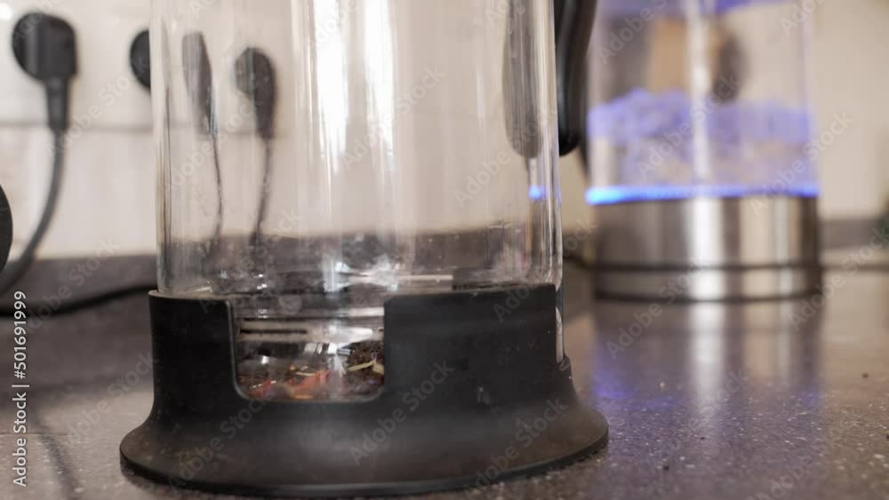 black tea leaves are poured into a teapot. making tea. traditional hot drink.