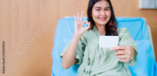 white card mockup in asian Beautiful woman patient hand sitting in hospital bed at medical center.