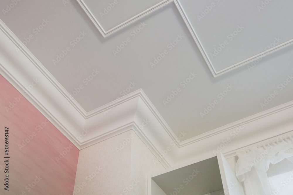 Fototapeta premium Detail of corner ceiling cornice with intricate crown molding.