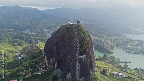 Aerial View Of Piedra del peñol monolith big black stone in Guatape, Antioquia - Colombia tourist site - drone shot