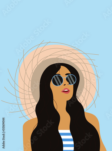 A girl with long hair in sunglasses, a hat and a striped T-shirt is enjoying a summer day.