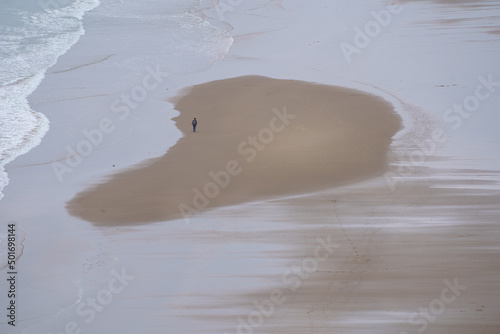 A lady having a walk along the Harlech Beach Wales photo