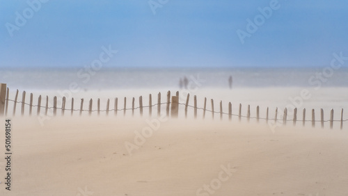 A misty shore due to sand on a windy day along the Traeth Abermaw Beach in Barmouth  Wales.