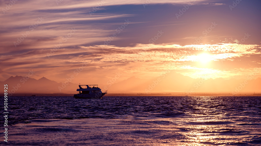 Sunset in fjords of Iceland with view of mountains and lonely ship yacht Sunset in fjords of Iceland with view of mountains and lonely ship yacht