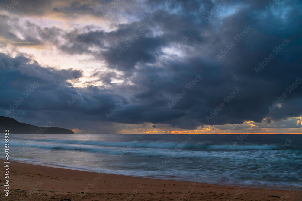 Fototapeta premium Overcast sunrise seascape with rain clouds