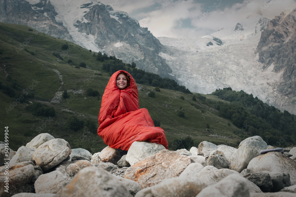 pretty girl tourist with red sleeping bag outdoor