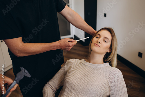 Young woman having meeting with plastic surgeon