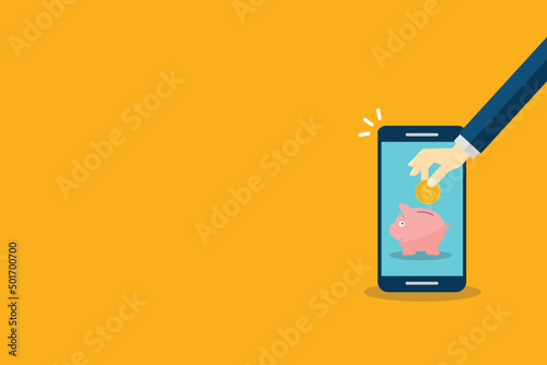 Donate, donation concept. Human hand with gold coin and piggy bank on mobile phone.