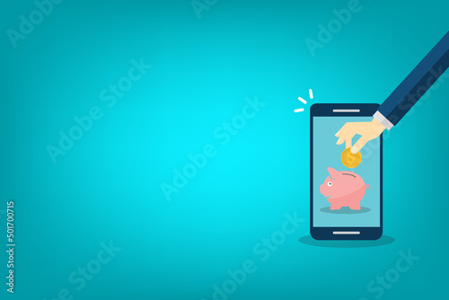 Donate, donation concept. Human hand with gold coin and piggy bank on mobile phone.
