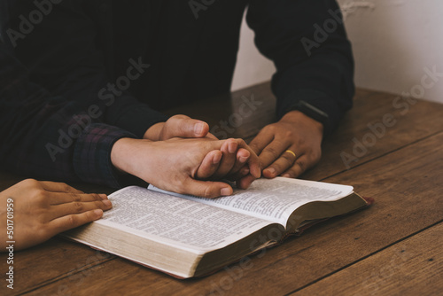 Two lovers Pray for god blessing to wishing have a better life. woman hands praying to god with the bible. begging for forgiveness and believe in goodness. Christian life crisis prayer to god.