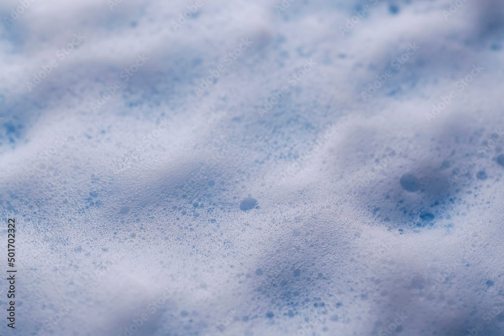 White foam on light blue background, closeup